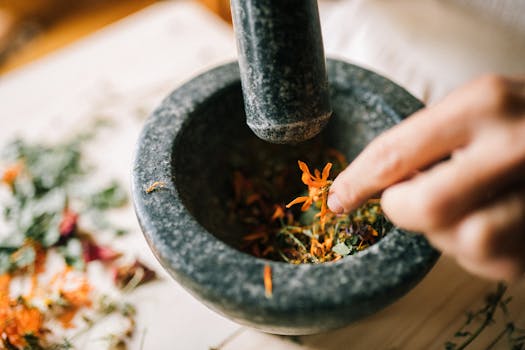 A Person Smashing Herbs Using a Mortar